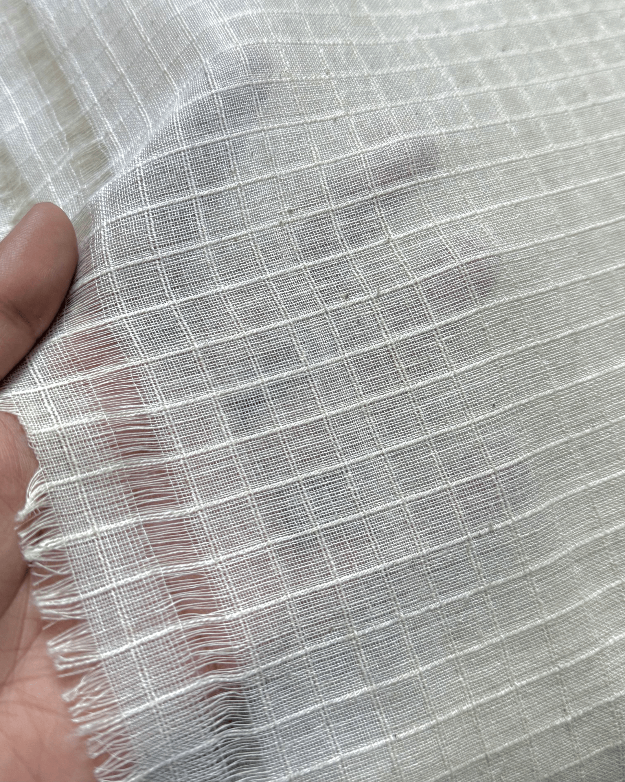 Close-up of handspun handwoven 33-count Indigenous Cotton Cord Check Weave Kora Fabric.