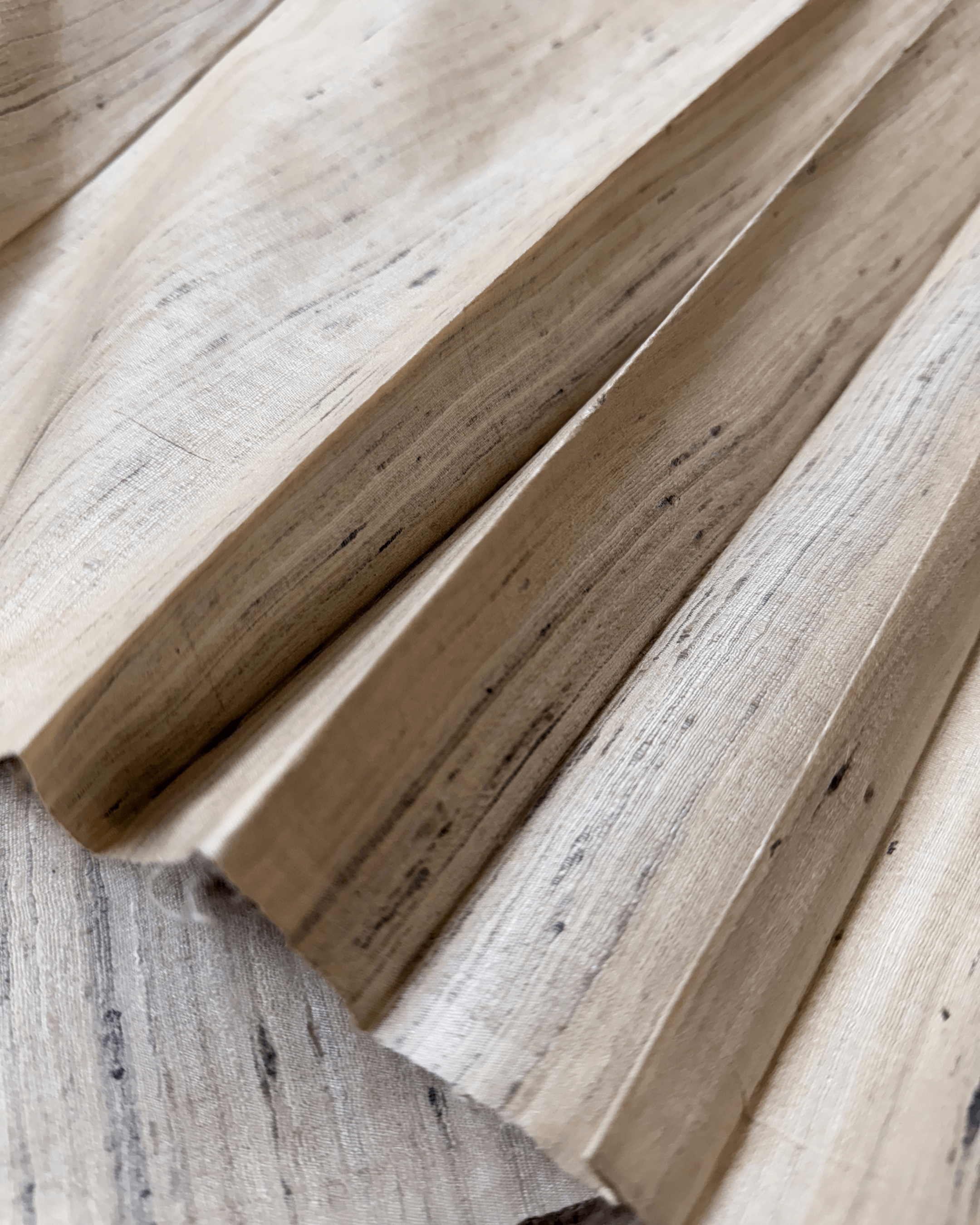 Close-up of hand spun Tassar silk fabric in raw color, showcasing its unique texture and natural fibers.